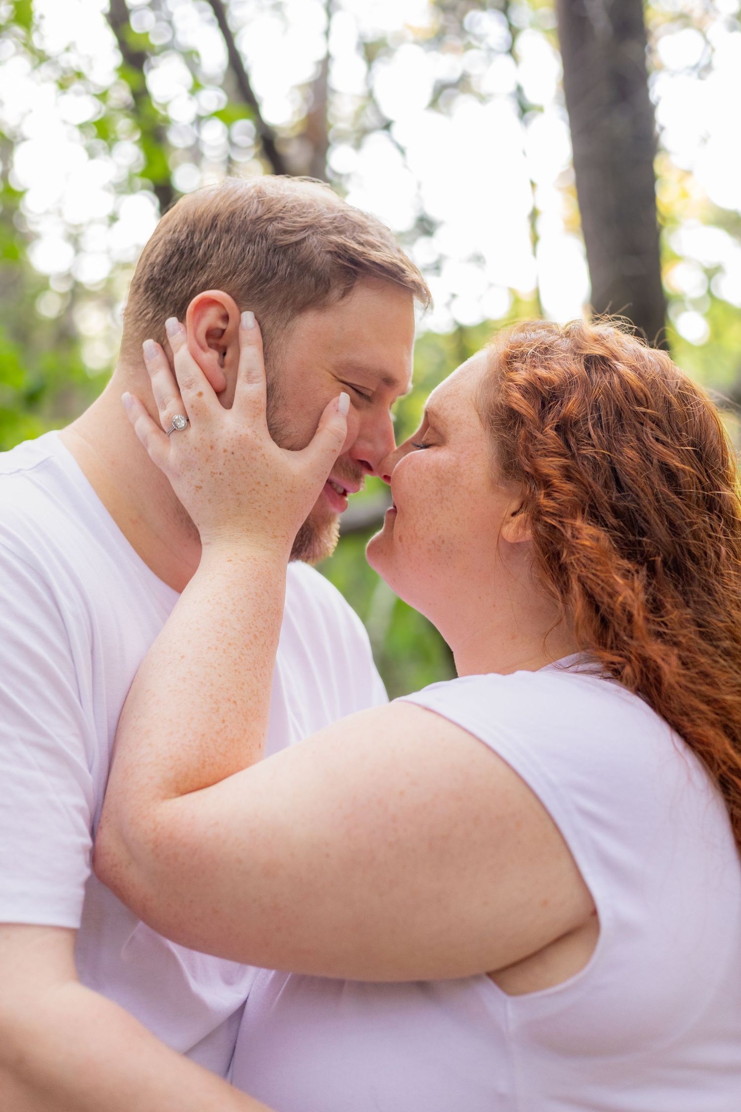 A romantic engagement photo session in a golden marsh field during sunset.