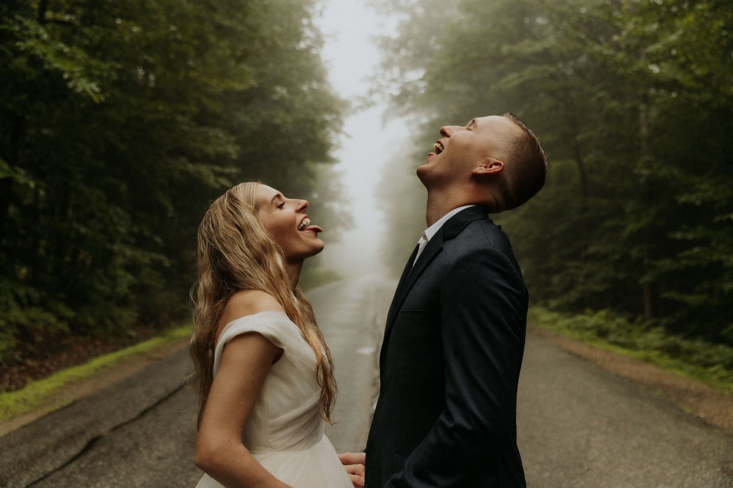 A romantic moment captured on a misty forest path.