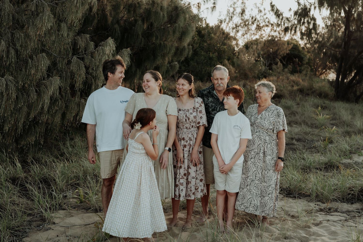 Family group portrait session outdoors with coordinated blue and white outfits at gladstone beach.