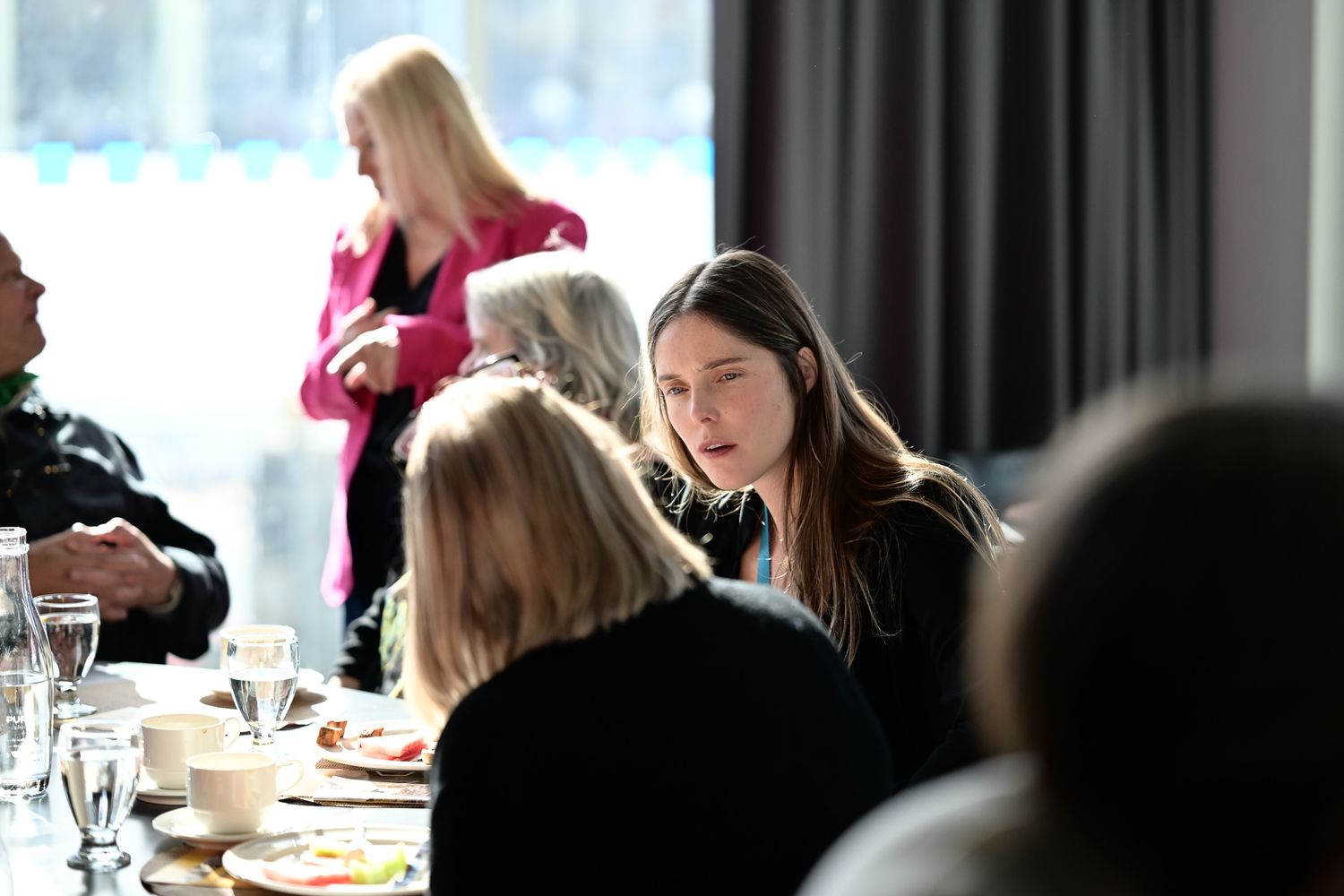 Rhiannon Morgan speaking with guests at a table during the St. John’s International Women’s Film Festival.