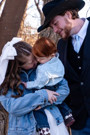 A couple looking lovingly at their son right before their wedding ceremony.