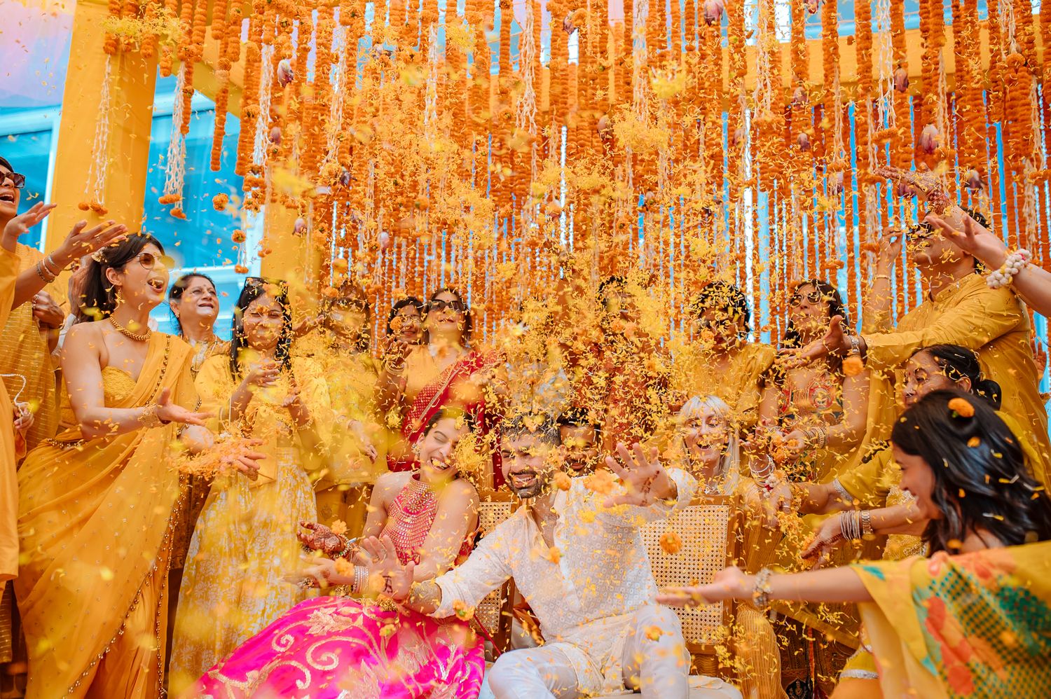Colourful flower petals raining over Shorye and Leah during the Haldi at Tivoli Chattarpur