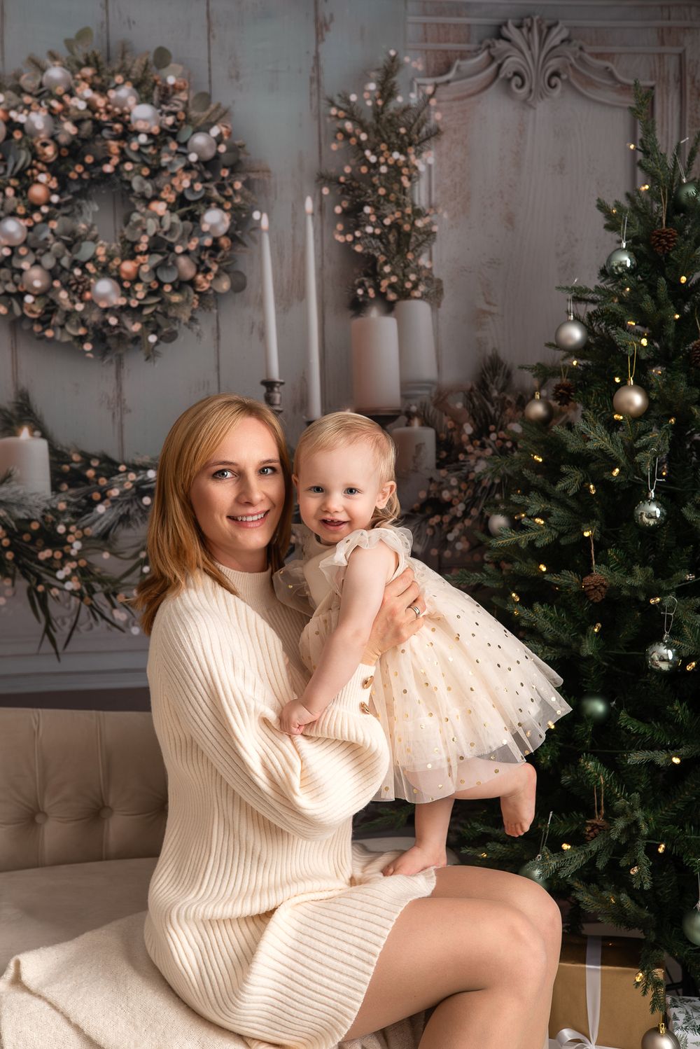 mum and daughter, sitting and smiling, christmas tree,