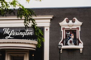 Architectural detail showing white ornamental trim and signage against dark brick building exterior.