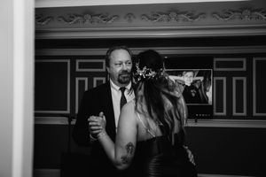 Black and white photos showing emotional moments during a wedding reception.