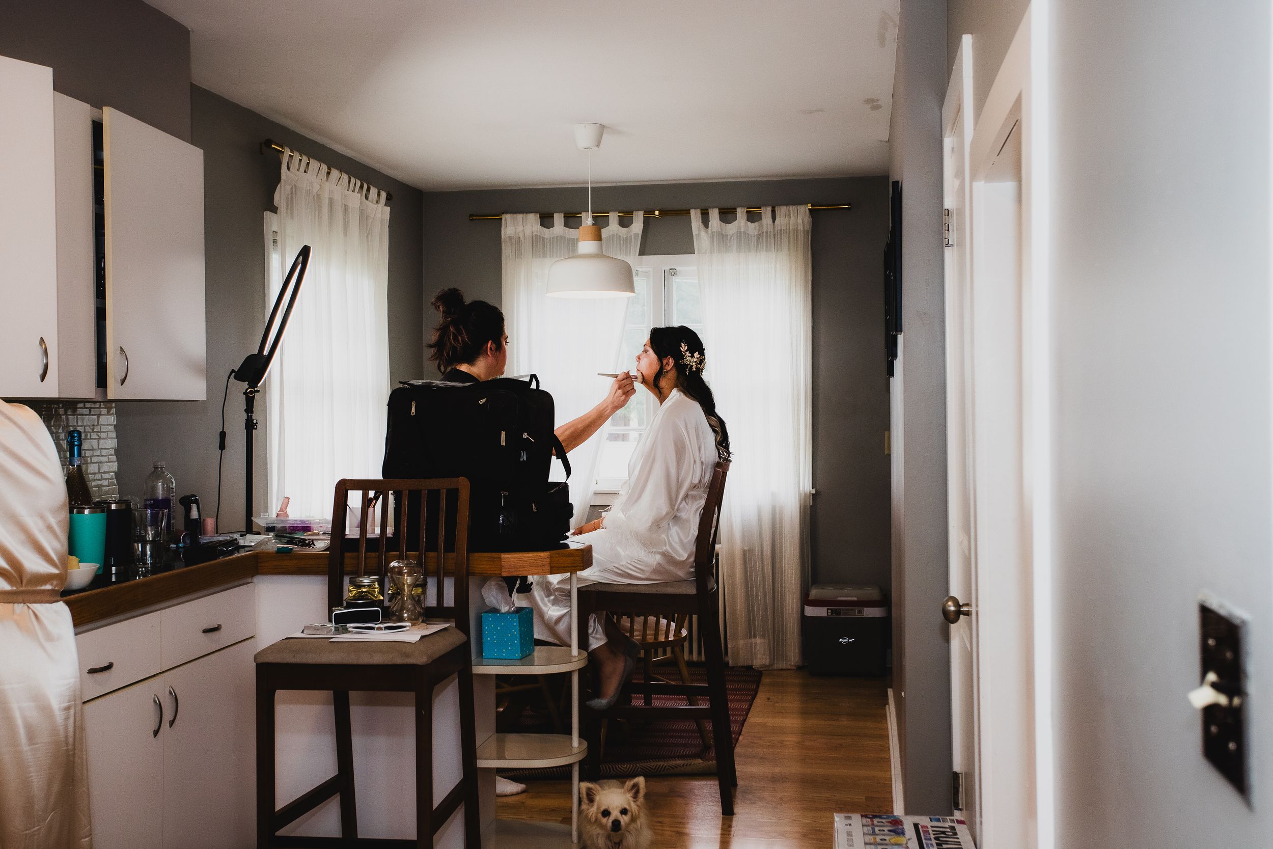 Interior shots of a modern home or venue with white walls and hardwood floors.