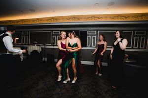 Dance floor scene with dramatic lighting and silhouettes against a warm glowing background.