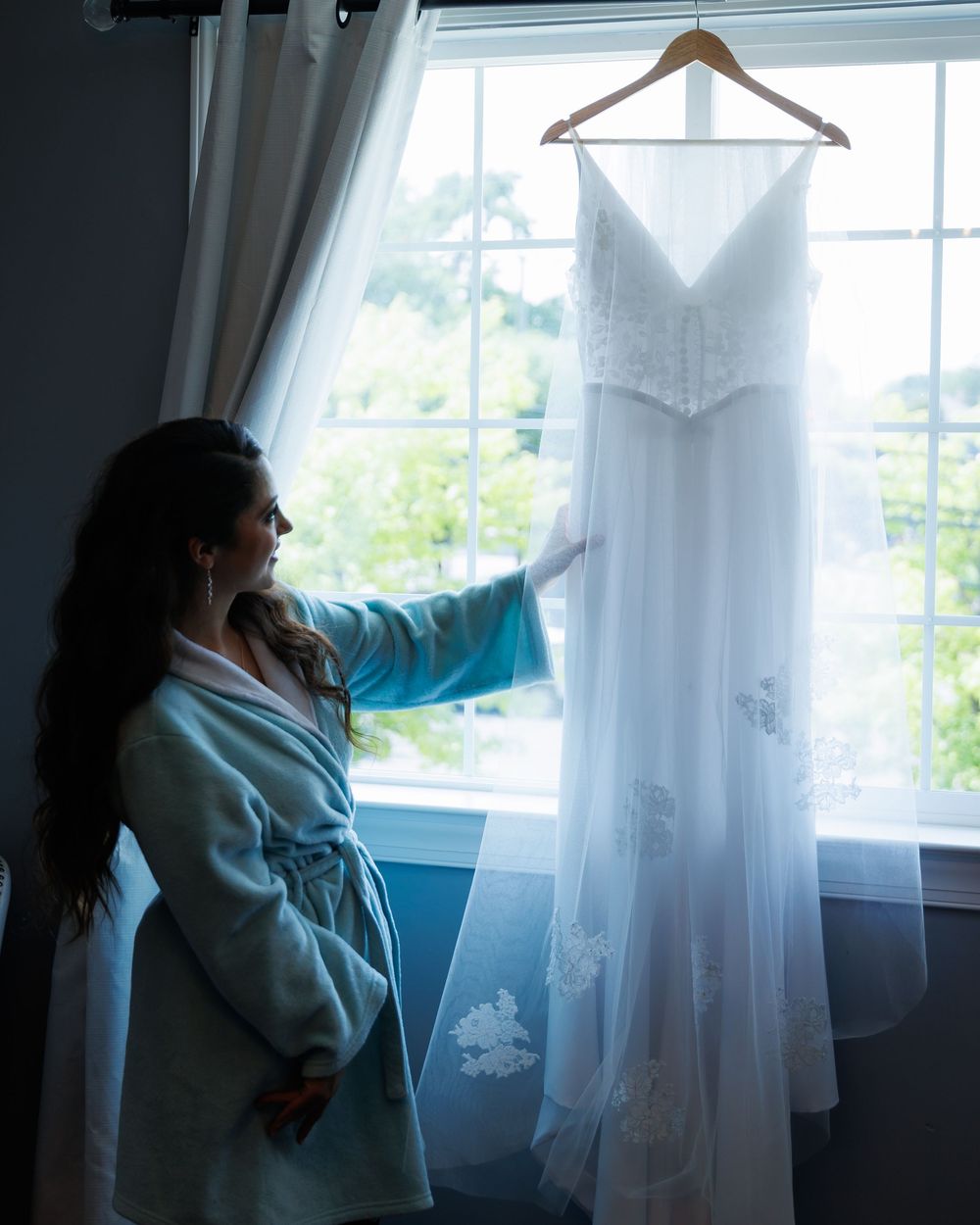 A series of moody portraits by a window with white curtains and natural lighting creating a dreamy atmosphere.