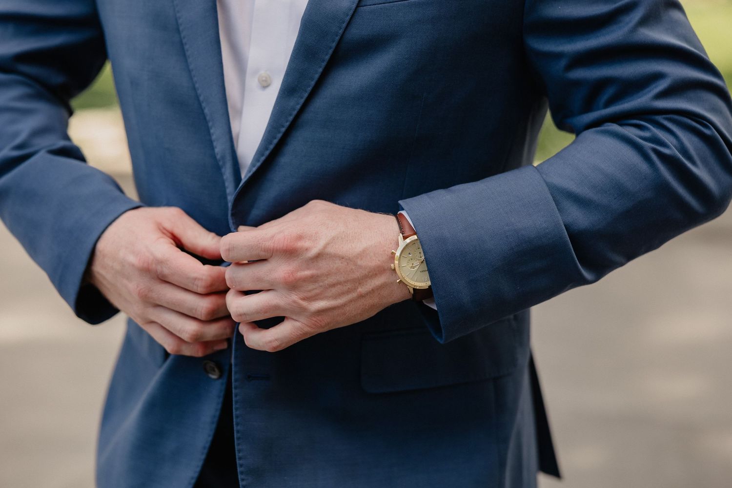 Close-up detail shots of a navy blue suit jacket with buttons and pockets.