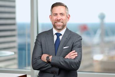 Professional headshot portraits of business people arranged in a grid layout against dark backgrounds.