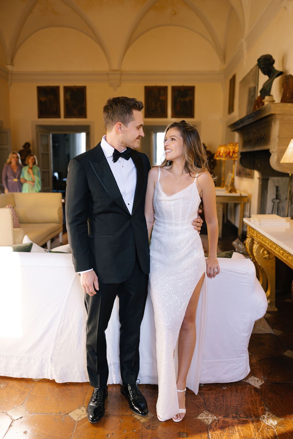 A series of wedding moments captured in an elegant indoor venue with arched ceilings.