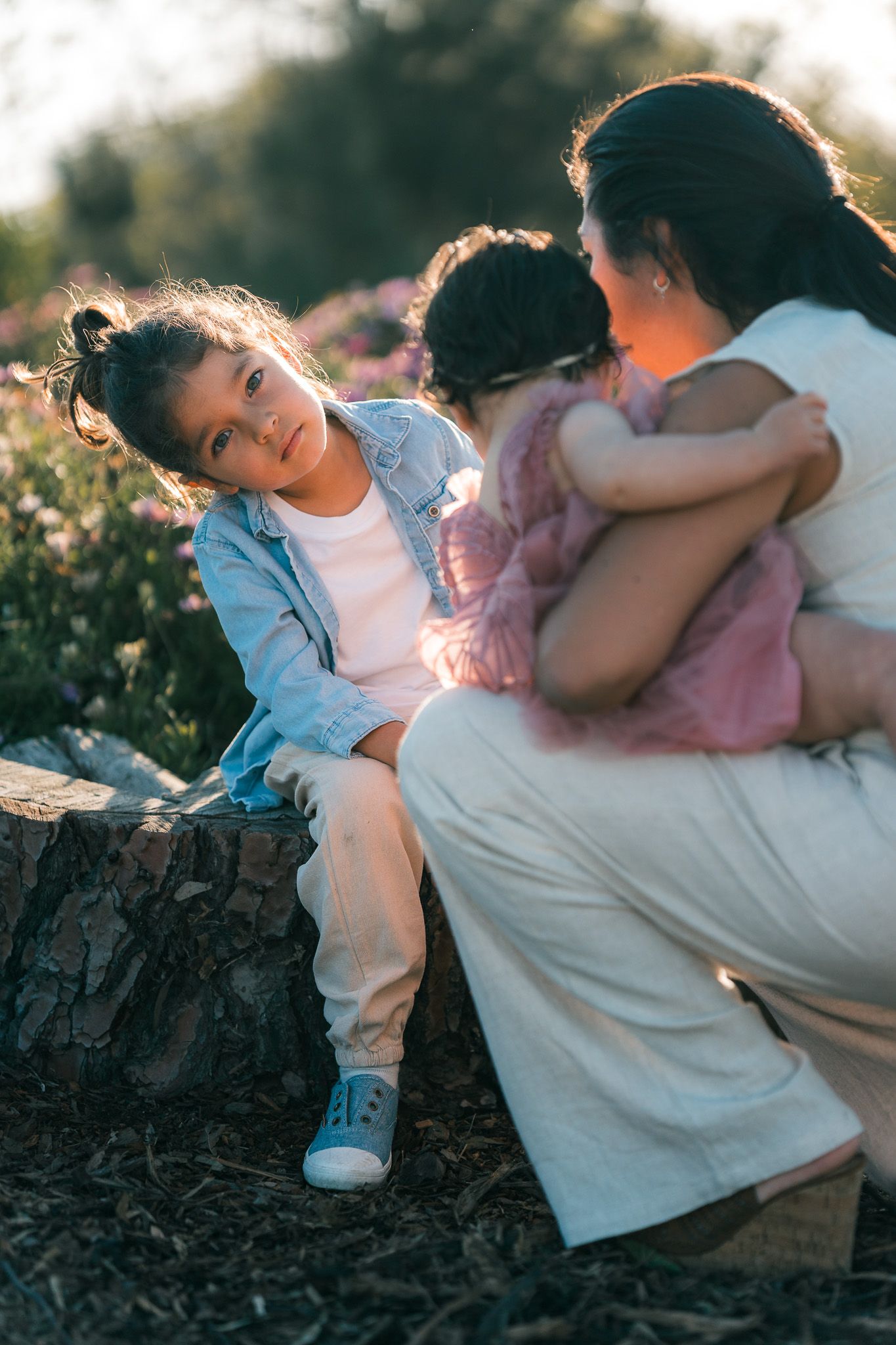 Child staring with expressive eye while having his clothes fixed by mom during a photoshoot - Mariano Alvarez, Newport Beach photography