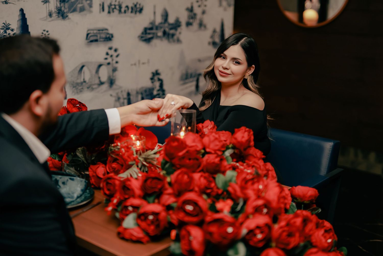 A romantic wedding celebration with vibrant red roses and candlelight creating an intimate atmosphere.