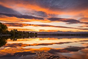 The sunset reflection was a fire in the sky with Longs Peak Mountain peeking out in Longmont, Colorado.