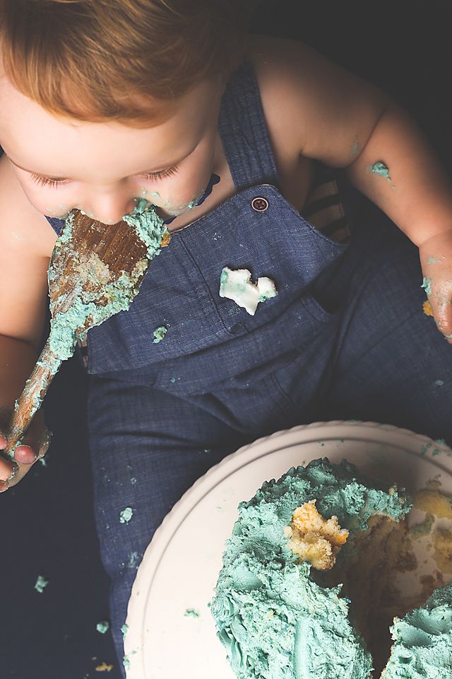 Sequence showing messy cake smash moments with mint green frosting on navy blue clothing.