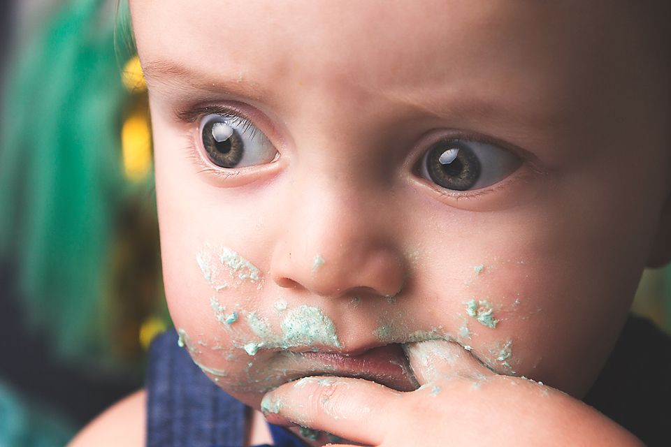 Close-up portrait showing glittery sparkles dusted across a baby's nose and cheeks.