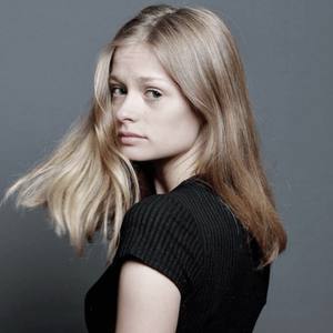 Side profile fashion portraits showing movement of shoulder-length hair against gray background.