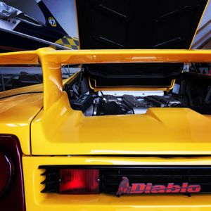 Series of yellow sports car detail shots showing sleek bodywork and Diablo badging.
