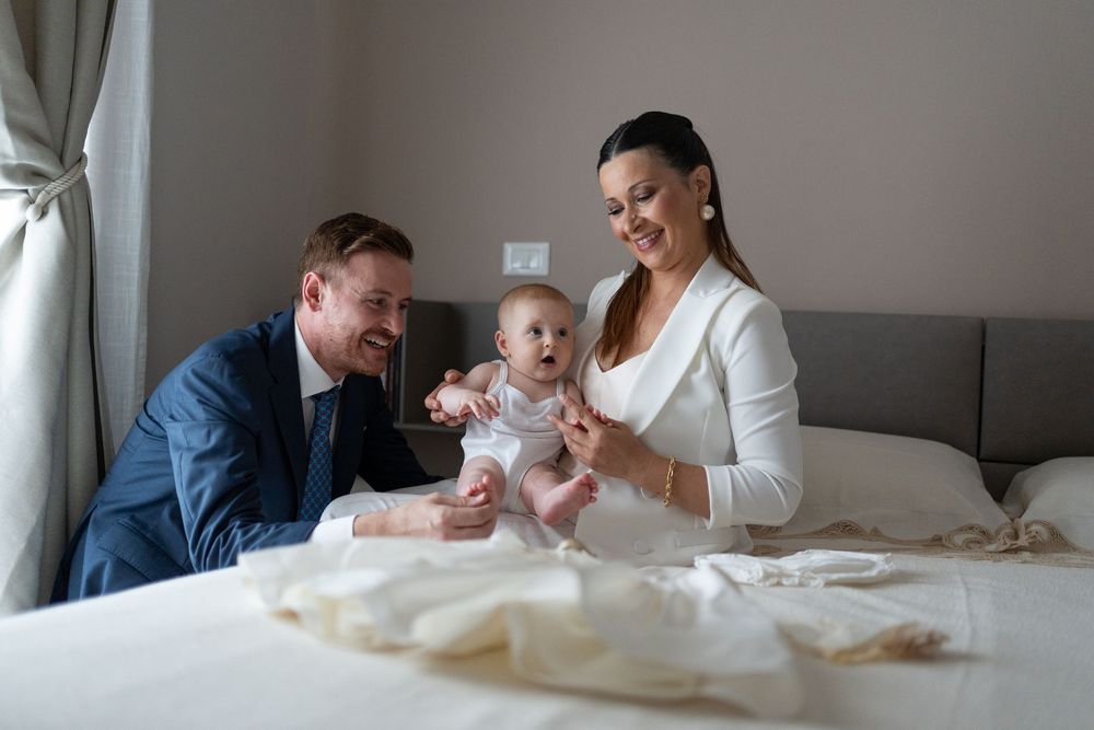 A series of candid moments showing a family celebrating a baptism ceremony in a warm indoor setting.