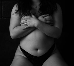 Black and white artistic nude photograph series showing torso and crossed arms in dramatic lighting and shadows.