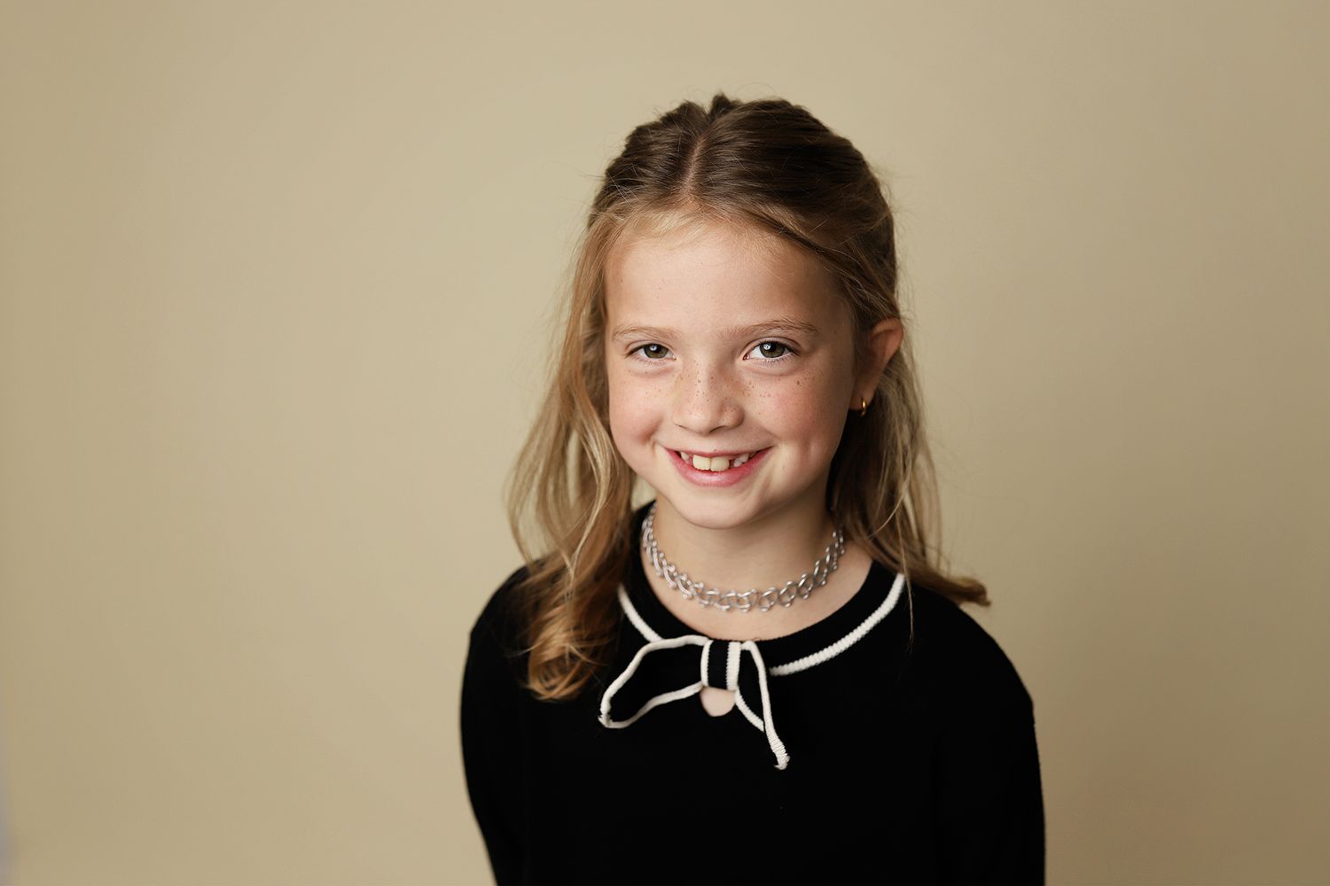 A series of portrait photos showing siblings posing together against a neutral beige backdrop.