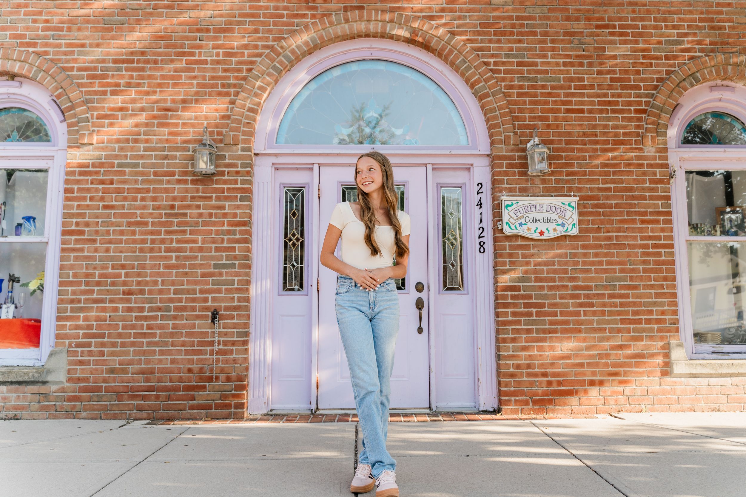Four connected photos showing someone posing against a brick wall with pink lockers in a school hallway setting.