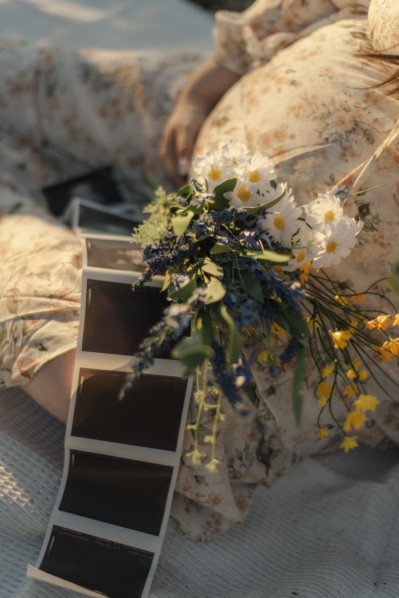 Pregnant woman sitting with flowers during sunset maternity session in Belton Texas