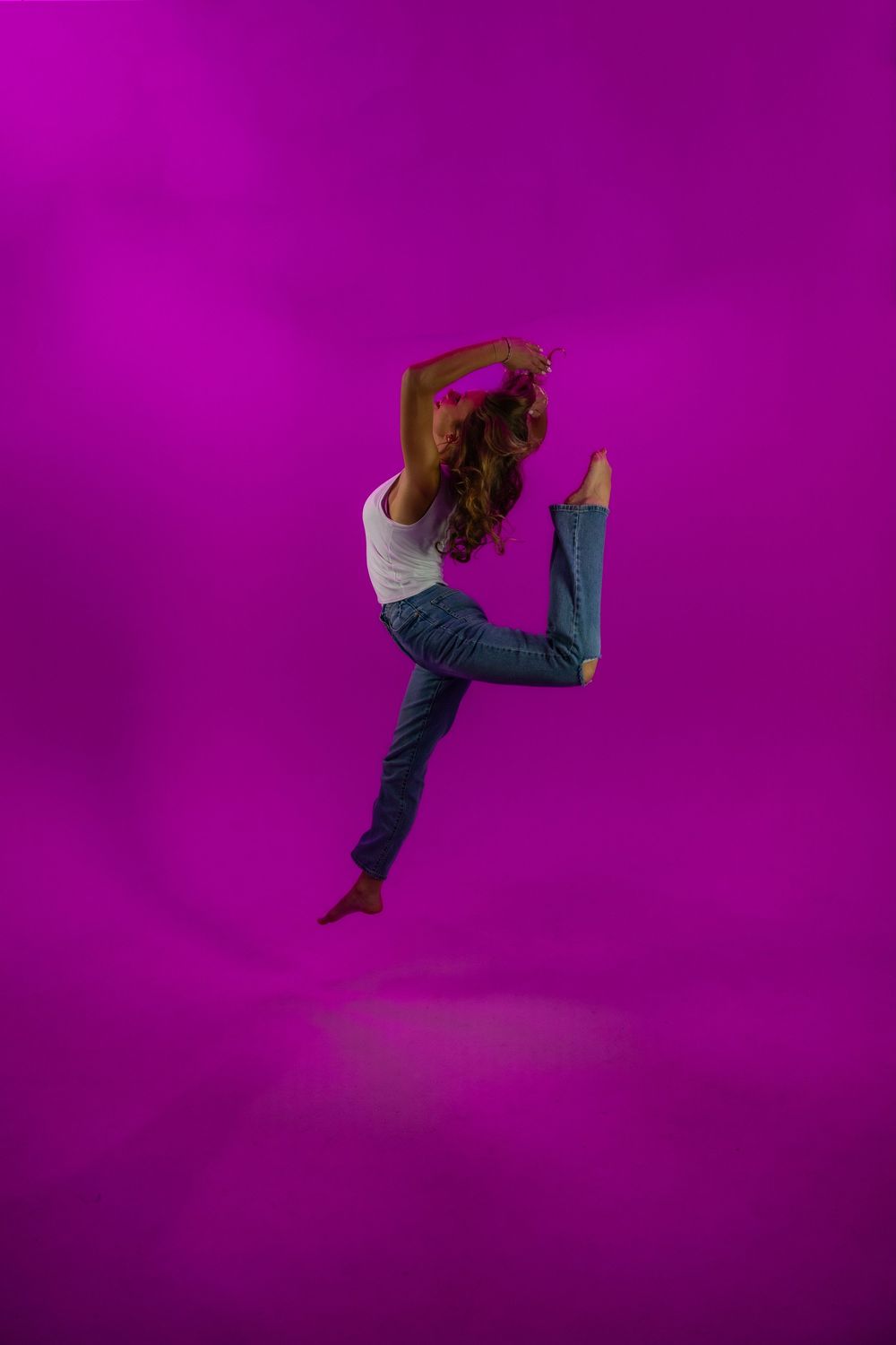 Sequence of dynamic dance moves showing legs and feet against a vibrant purple background.