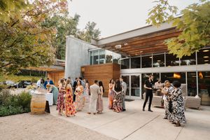 Modern outdoor wedding venue with wooden beams and autumn foliage creating a natural, elegant atmosphere.