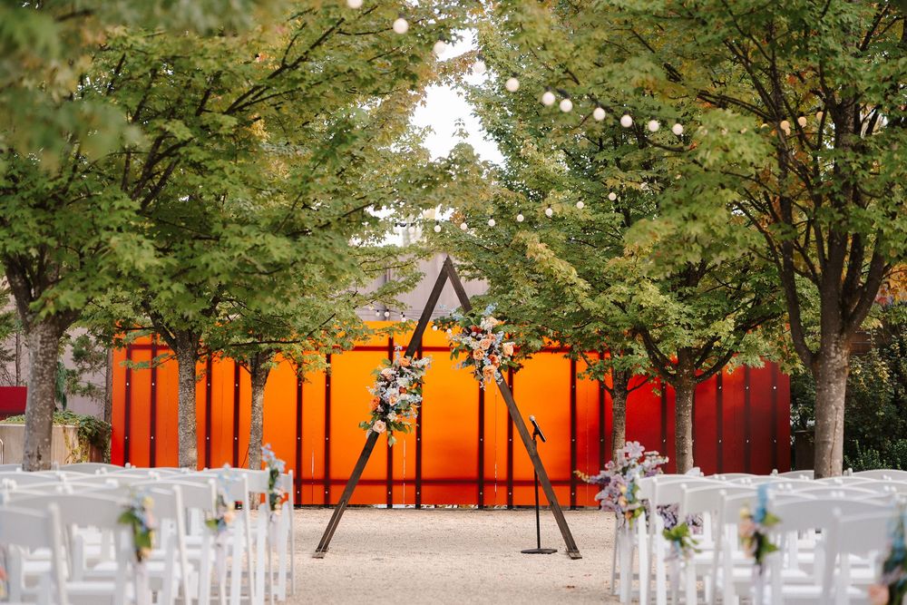 Orange gates line a tree-filled pathway at the Gates Foundation Discovery Center in Seattle.
