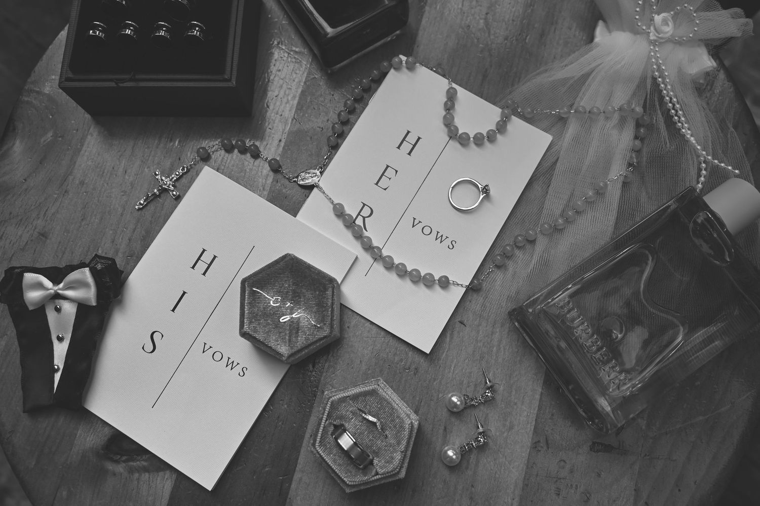 Overhead view of handwritten notes and sketches scattered on a dark surface with pencils and writing materials.