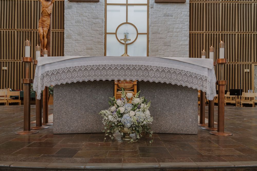 Modern church interior with white stone walls and wooden architectural details.