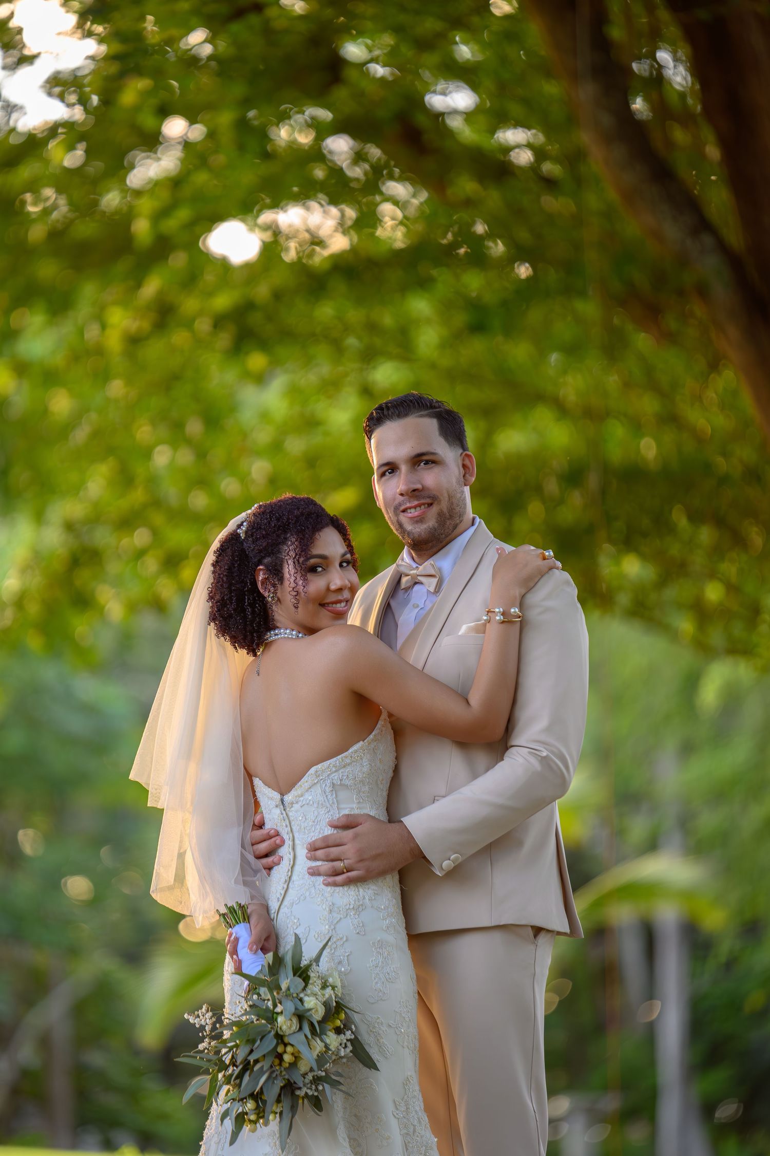 Sosua–Cabarete wedding photography capturing Kaina and Youri at Sea Horse Ranch during golden hour, surrounded by tropical forest and ocean