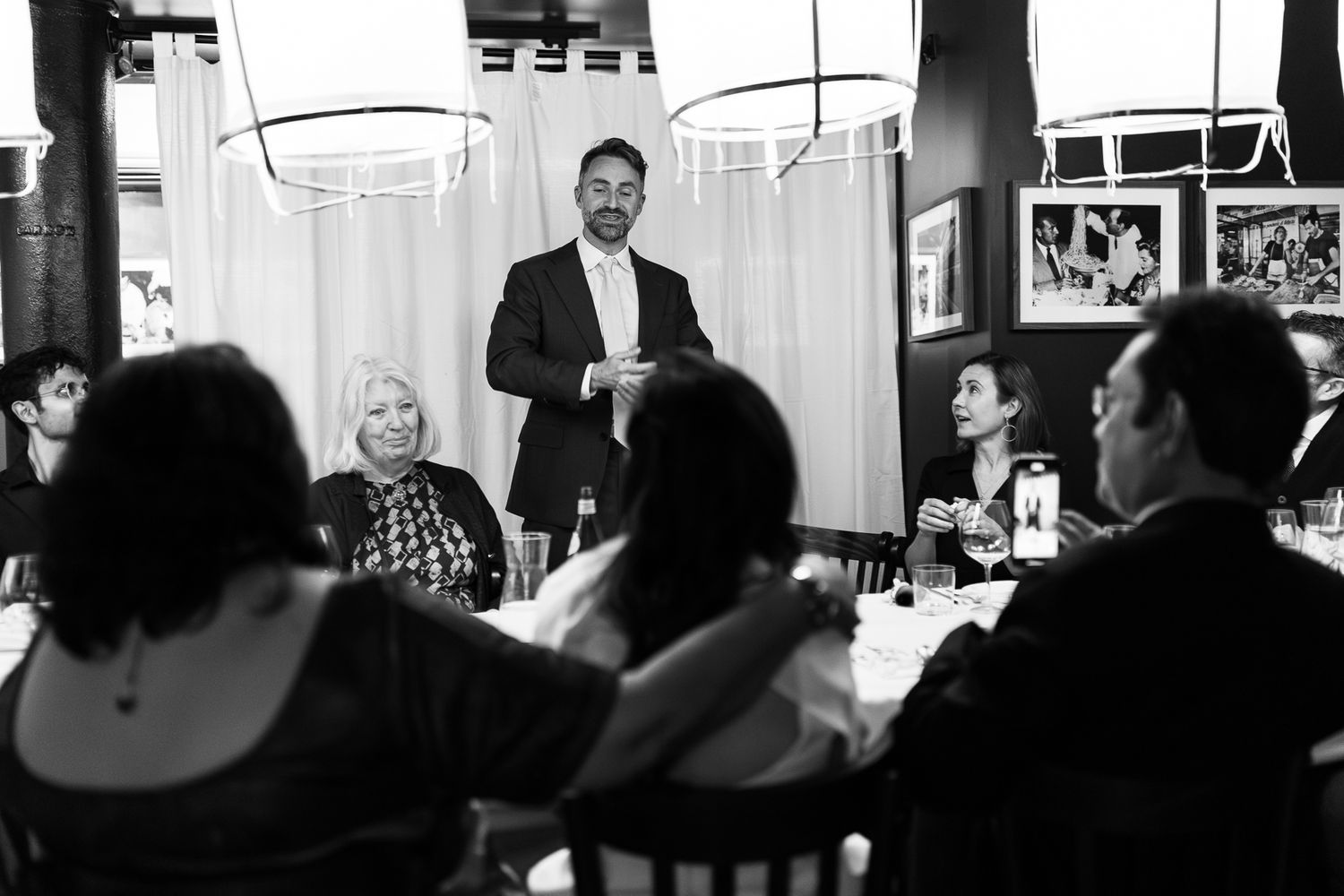 groom giving speech at wedding reception in a restaurant