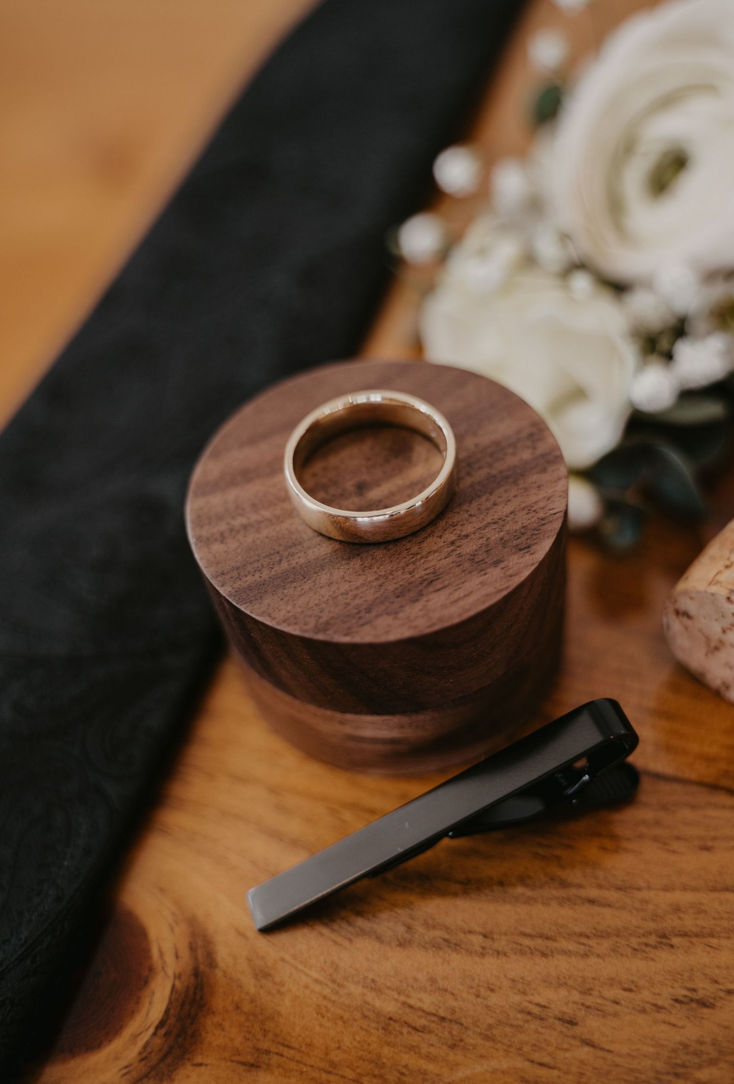 Wedding ring displayed on a wooden ring holder in a series of close-up shots.