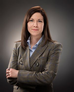 Professional portrait series showing a businesswoman in a plaid blazer against a dark gradient background.
