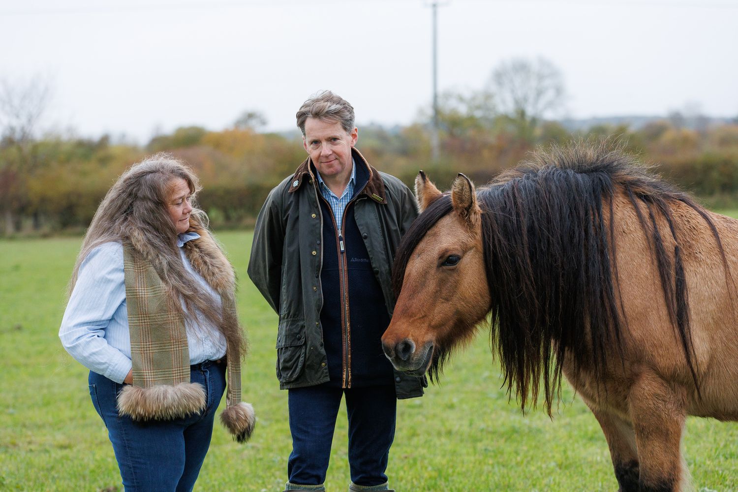 A woman in a brown leather jacket shares tender moments with a black horse in a series of intimate portraits.