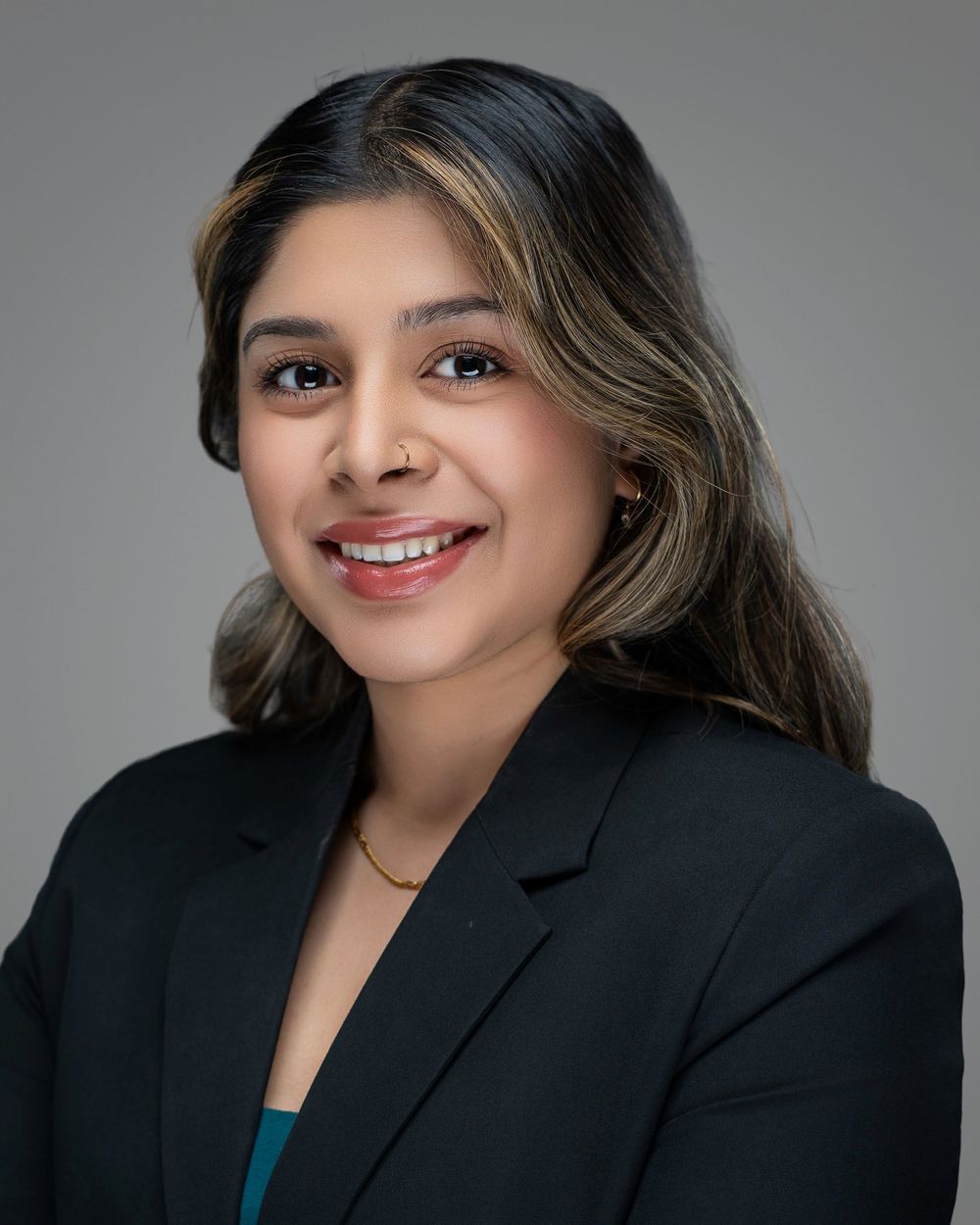 Kelly Photography Atlanta Professional portrait of person in black blazer against grey studio background. Atlanta GA