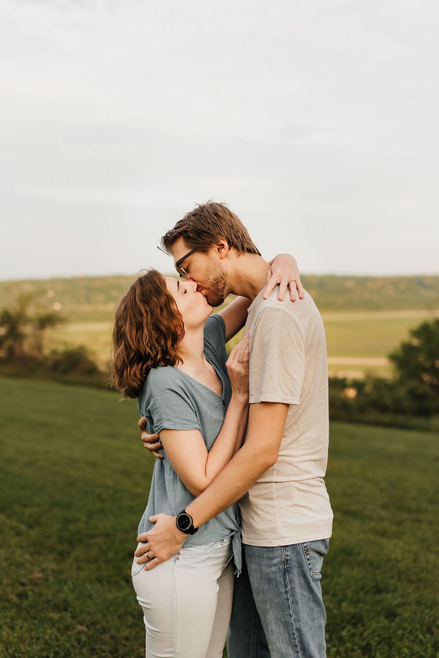 Husband and wife kiss passionately at their photo session.