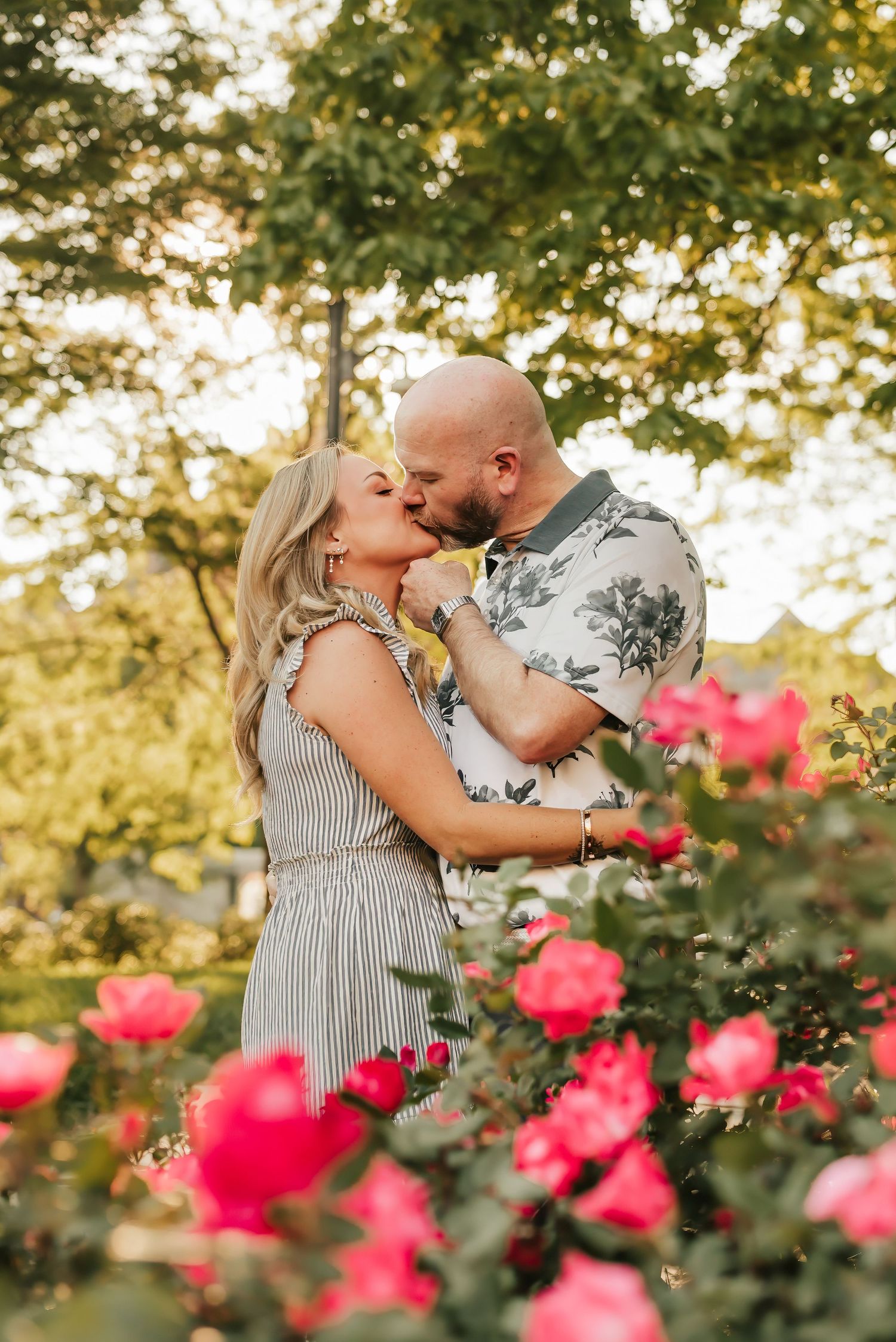 Husband and wife kiss in the rose garden at Washington Park in OTR.