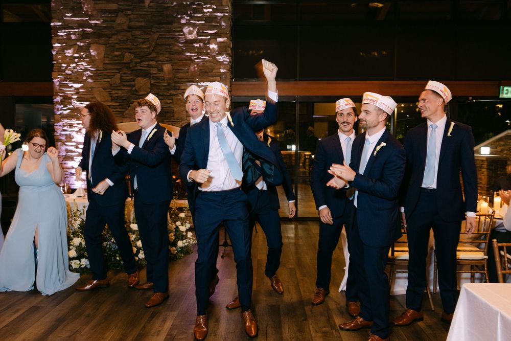 Guests enjoying themselves on a dance floor with stone walls and ambient lighting.