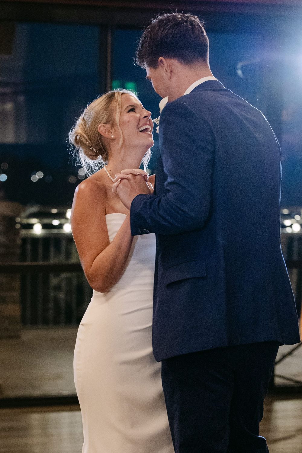 Newlyweds share an intimate dance together on their wedding day in an elegant venue.