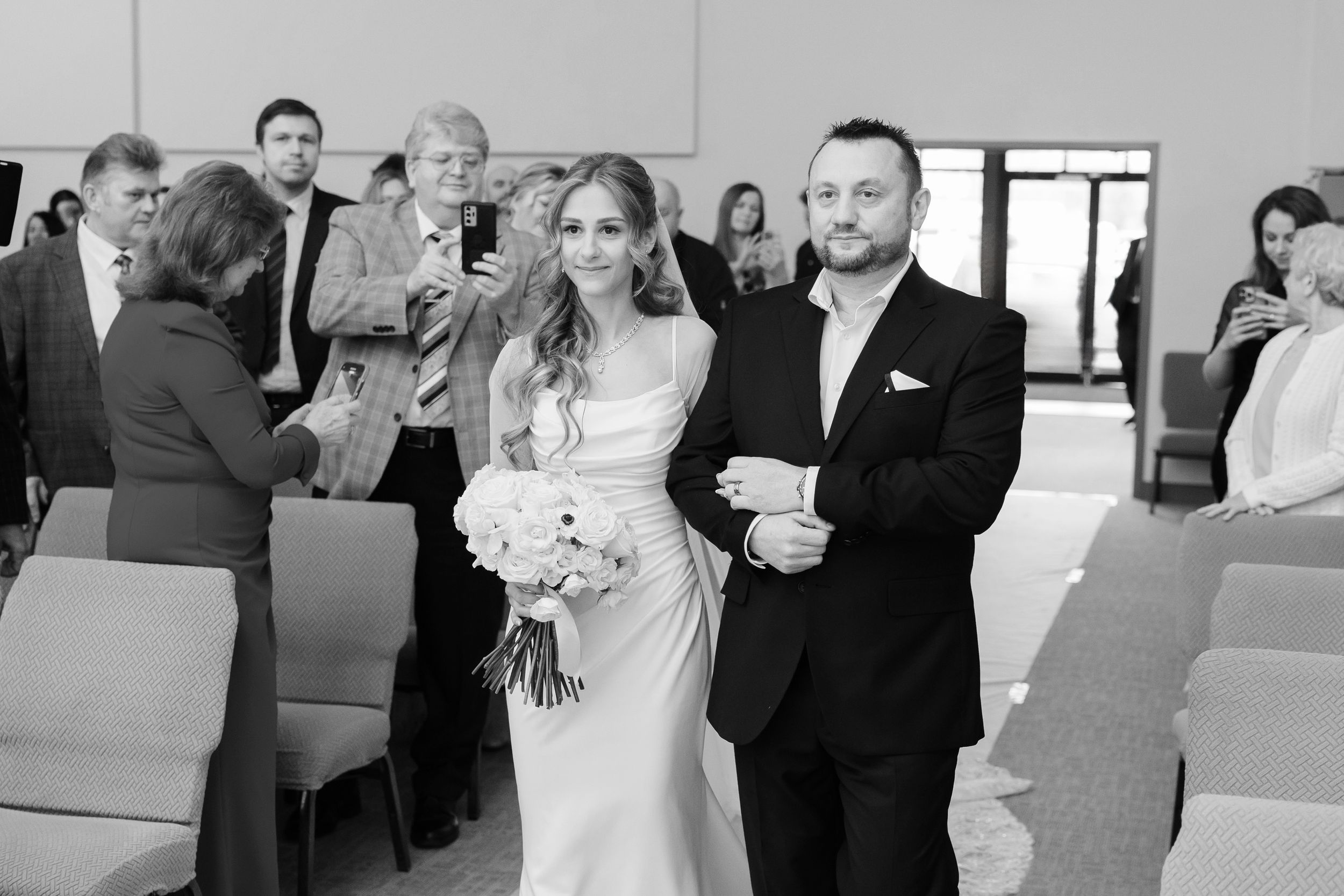 Bride escorted by father down aisle during Ohio wedding ceremony photographed by Tom Forrest from Hudson, Ohio.