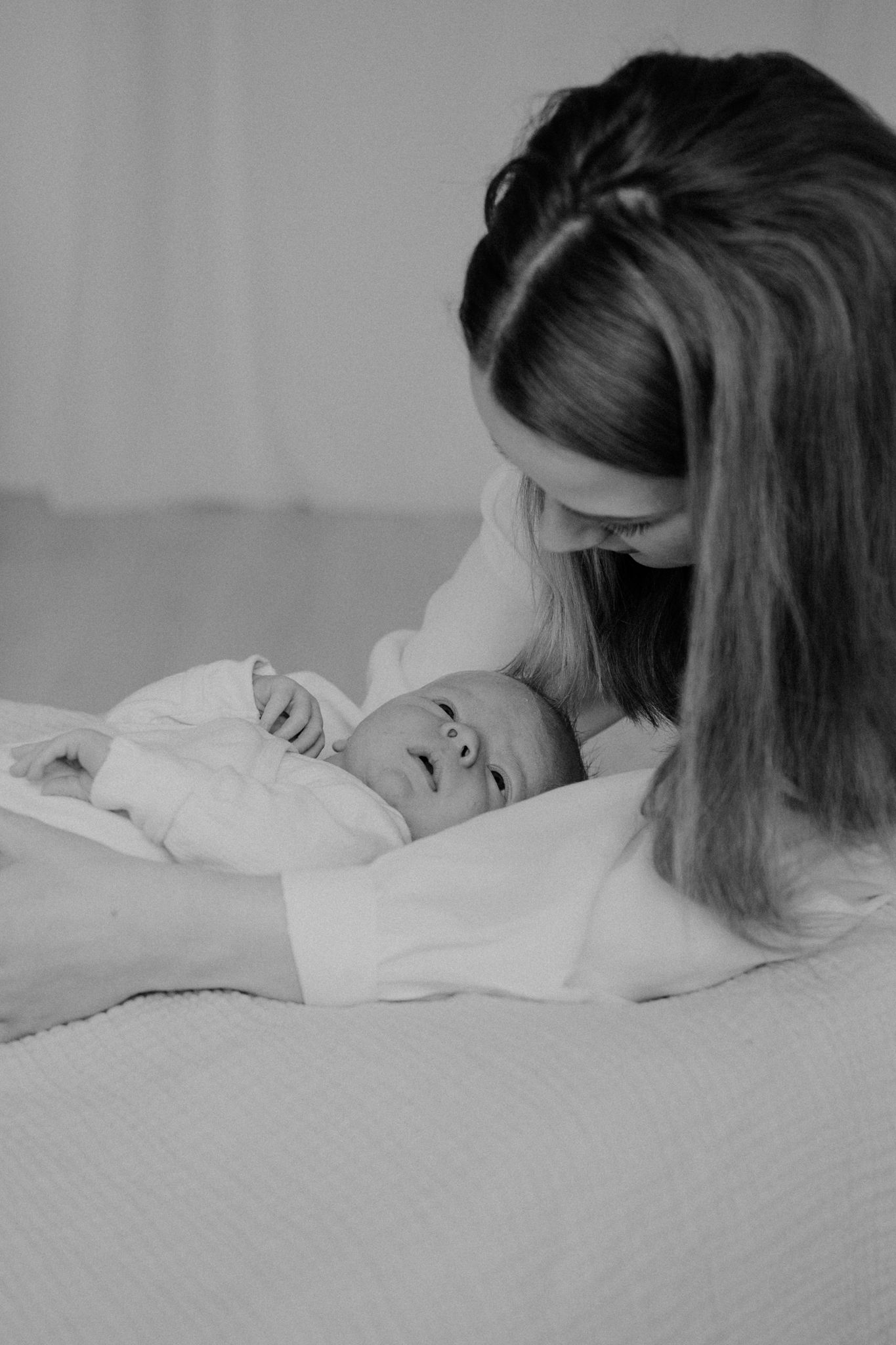 A black and white photo sequence shows a person sleeping peacefully on a white bed.
