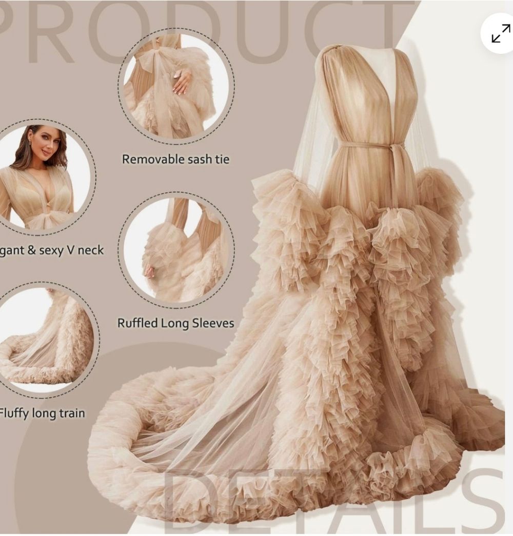 Elegant champagne tulle gown with ruffled long sleeves, plunging neckline, removable sash tie and dramatic fluffy train.