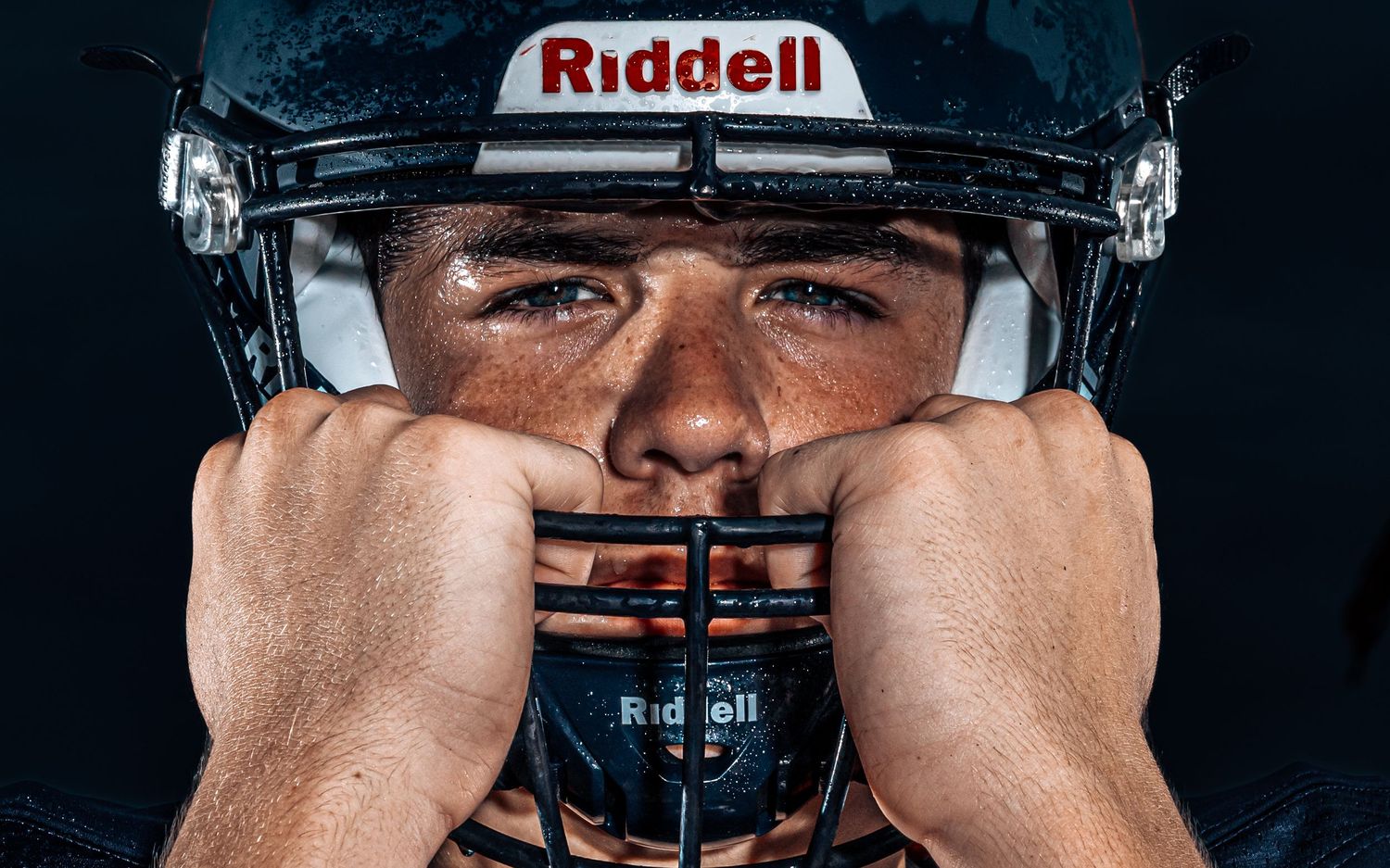 High school football player Media Day close-up portrait with Riddell helmet, by Deanna Fox, SportsFox Photography, Hershey PA
