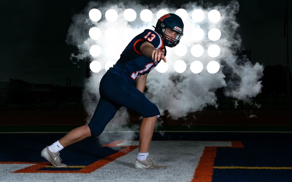 Hershey Trojans football player Media Day action pose with smoke effects and stadium lights, by Deanna Fox, SportsFox Photography, Hershey P