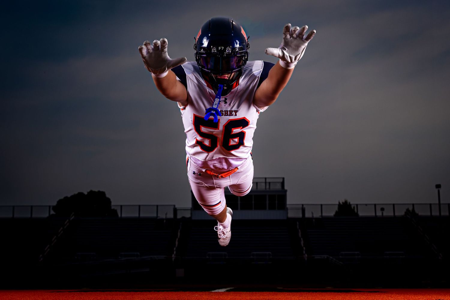 Hershey Trojans football player, #56, diving catch pose, Media Day portrait, by Deanna Fox, SportsFox Photography based in Hershey PA