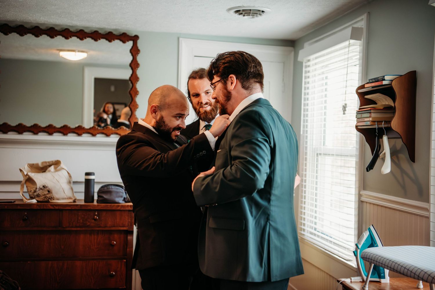Wedding preparations taking place in an intimate indoor setting with natural window light.