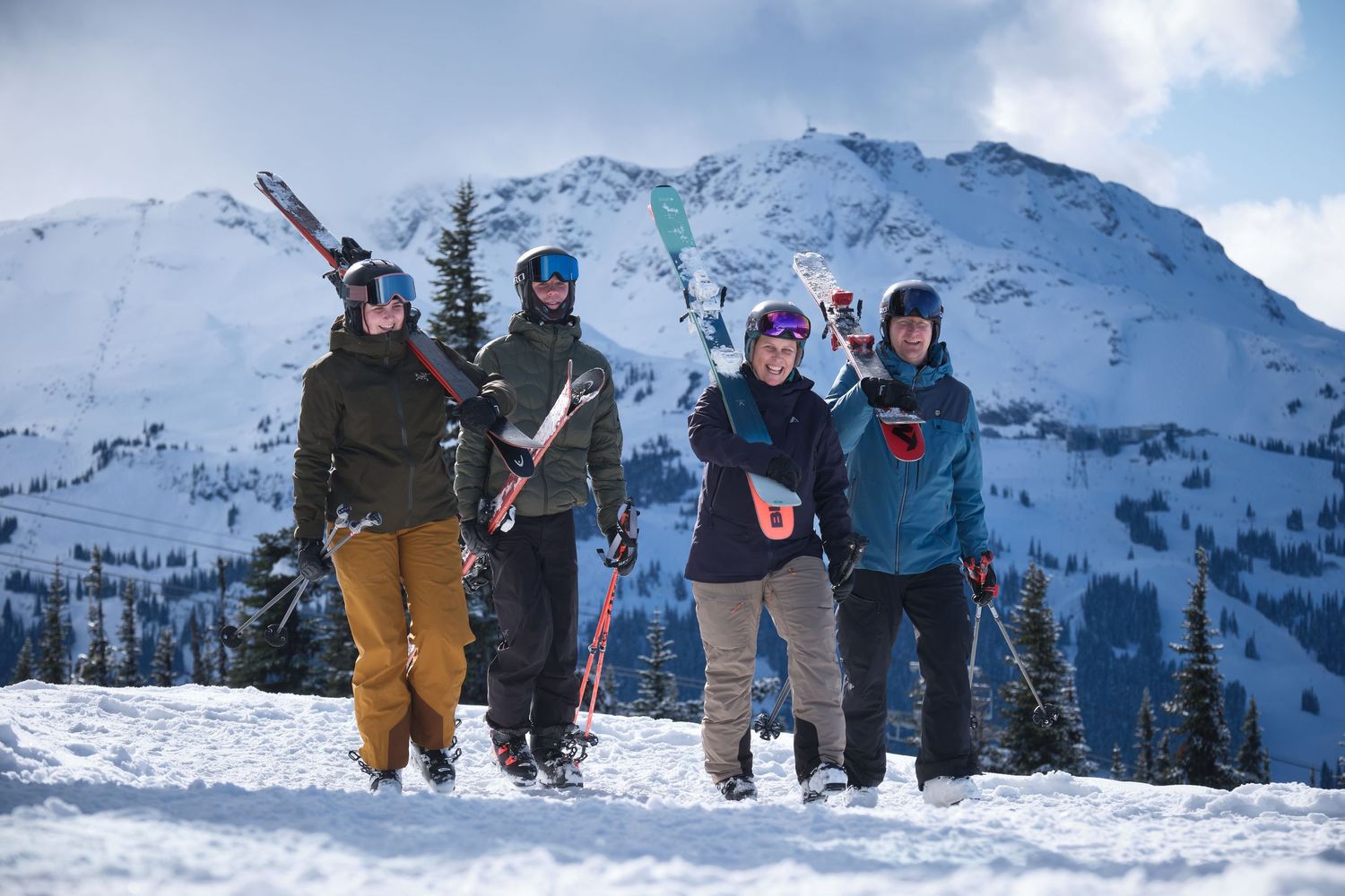Two winter sports enthusiasts share a friendly moment while skiing in a snow-covered mountain forest setting.
Whistler Blackcomb